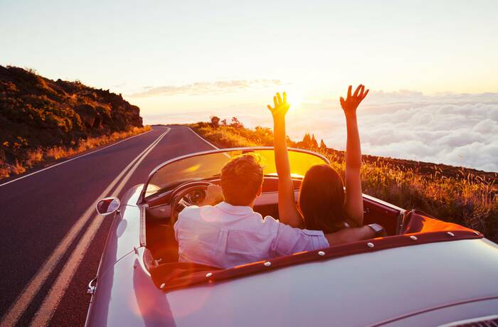 couple in open top car